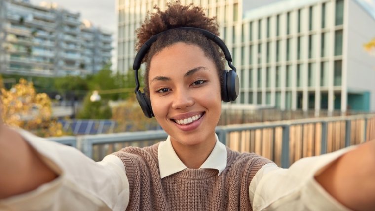 7 Coping Mechanisms for Students and How to Manage Stress in Collage A smiling female college student taking a selfie | 7 Coping Mechanisms for Students and How to Manage Stress in College