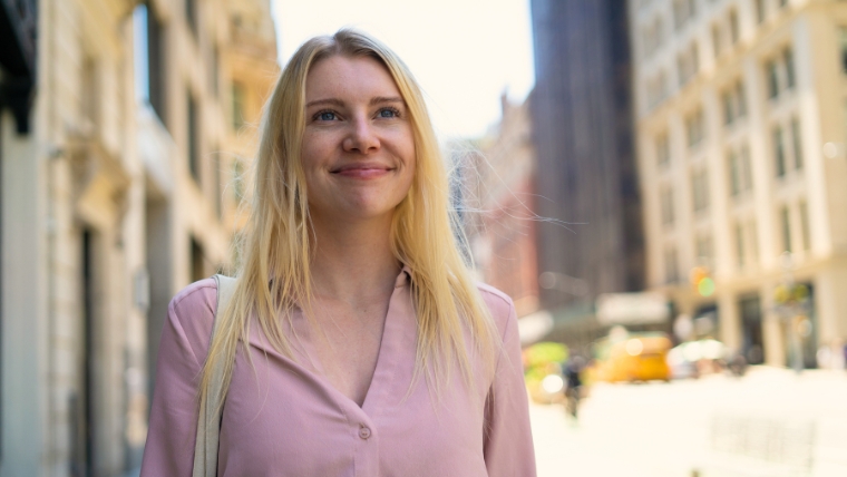 Psychotherapy for OCD 7 Benefits of Exposure and Response Prevention (ERP) Woman smiling confidently and optimistically on a city street | Psychotherapy for OCD 7 Benefits of Exposure and Response Prevention (ERP)