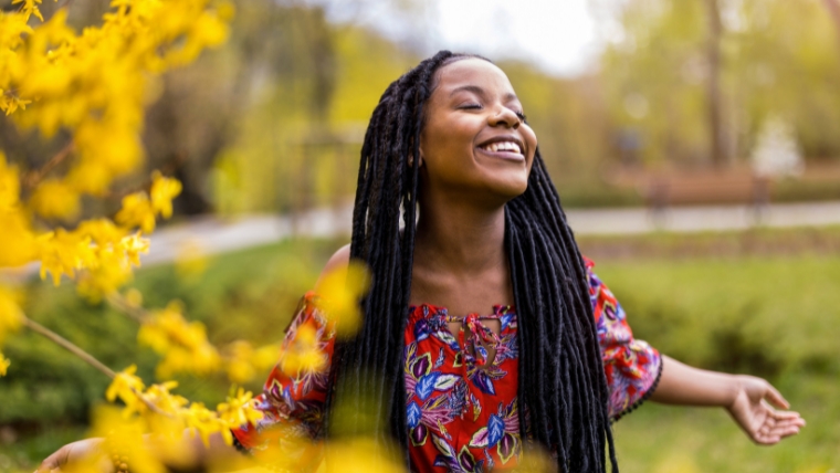 Can-Psychedelics-Replace-Antidepressants A woman standing outside on a spring day with her arms out, her head tilted up, smiling | Can Psychedelics Replace Antidepressants? | Mindful Health Solutions