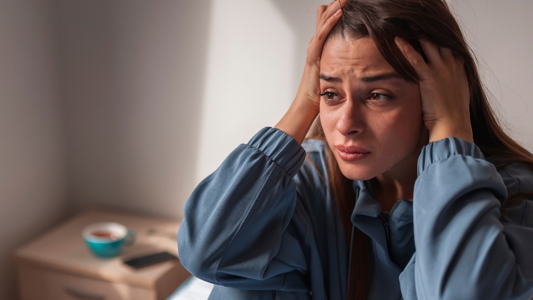 The-10-Personality-Disorders-and-How-to-Treat-Them Upset woman on bed holding head in hands | The 10 Personality Disorders and How To Treat Them | Mindful Health Solutions