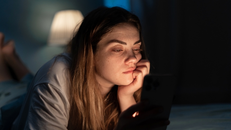4 Ways Information Overload Impacts Our Mental Health and How To Cope 4 Ways Information Tired woman on smartphone at night in bed | 4 Ways Information Overload Impacts Our Mental Health and How To Cope | Mindful Health Solutions
