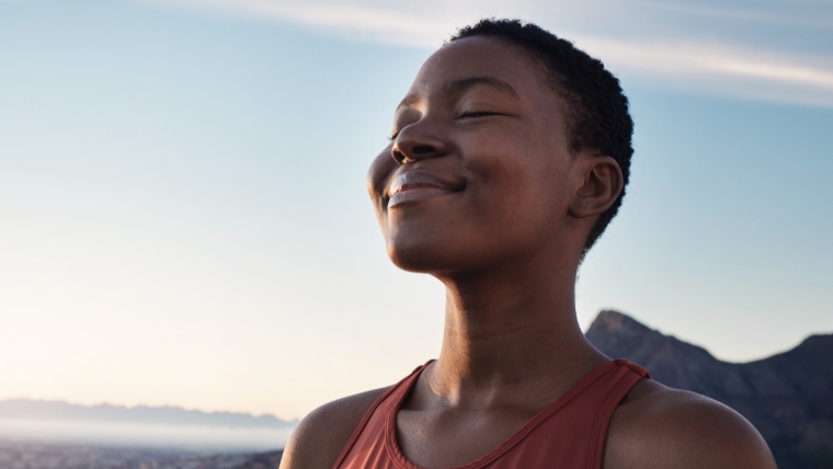 How TMS Literally Changes Your Mind Medication-Free Depression Treatment Black woman outside breathing with a smile on her face | How TMS Literally Changes Your Mind Medication-Free Depression Treatment | Mindful Health Solutions