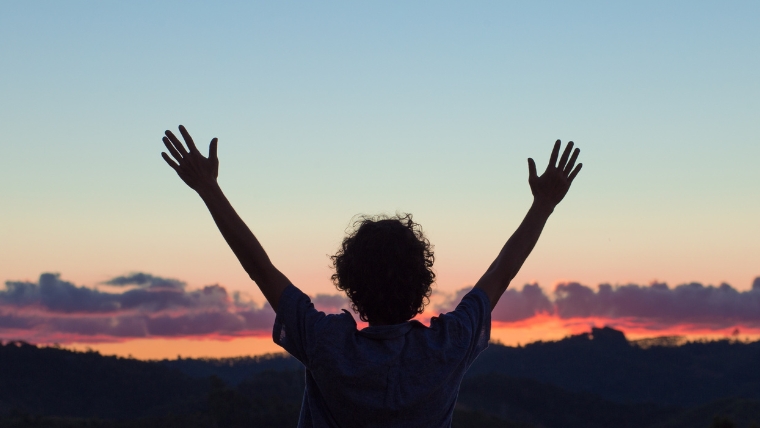 How-To-Transform-Your-Life-with-a-Consistent-Gratitude-Practice A silhouette of a person with open arms in front of a sunset | How To Transform Your Life with a Consistent Gratitude Practice | Mindful Health Solutions