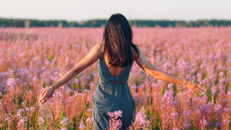 Ditch-the-Chocolates-Why-Your-Mental-Health-Matters-This-Valentines-Day Woman in a field of purple flowers | Ditch the Chocolates Why Your Mental Health Matters This Valentine's Day | Mindful Health Solutions