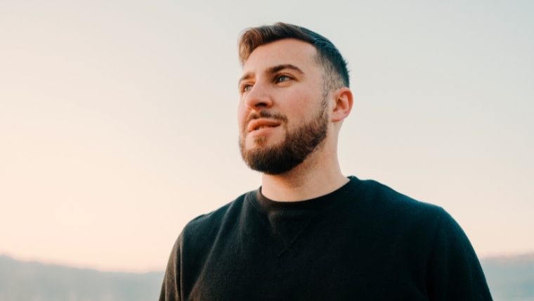 Accelerated-dTMS-The-Day-to-Day-of-this-Powerful-Depression-Treatment A person standing outside looking up and out toward the horizon with a hopeful expression | Accelerated dTMS The Day-to-Day of this Powerful Depression Treatment | Mindful Health Solutions