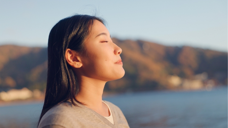Blog-Post-Featured-Images-13 Woman by the mountains and a lake breathing in fresh air with sun on her face | Let's Break Down These 5 Myths About Ketamine Infusion Therapy | Mindful Health Solutions