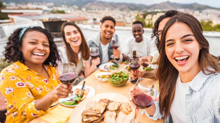 10 Ways To Successfully Handle Social Gatherings with Social Anxiety A group of friends at a rooftop dinner party | 10 Ways To Successfully Handle Social Gatherings with Social Anxiety | Mindful Health Solutions