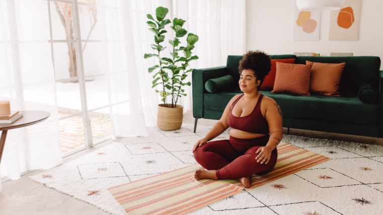 13-Surprising-Ways-Body-Image-Impacts-Your-Mental-Health A person peacefully going yoga in their living room | 13 Surprising Ways Body Image Impacts Your Mental Health | Mindful Health Solutions