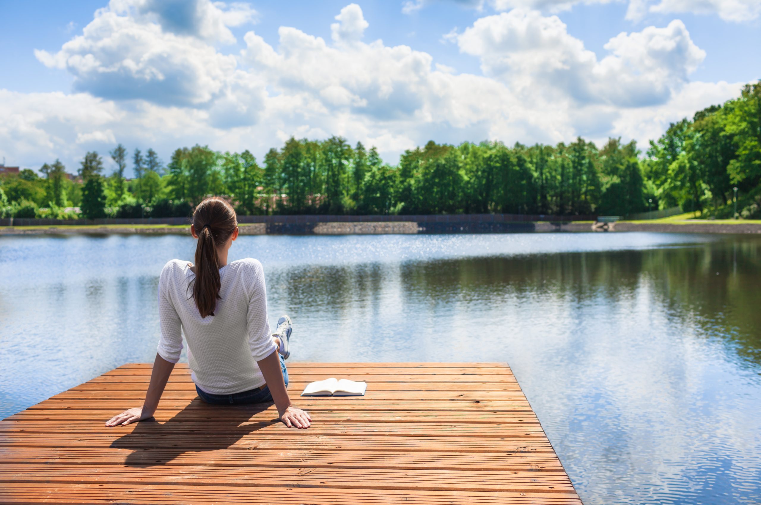 Woman relaxing by a beautiful lake.
