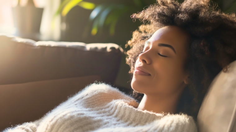 24 Ways to Transform Negative Thoughts with Cognitive Behavioral Techniques Woman laying on her couch, at peace, taking a deep breath, slightly smiling | 24 Ways to Transform Negative Thoughts with Cognitive Behavioral Techniques