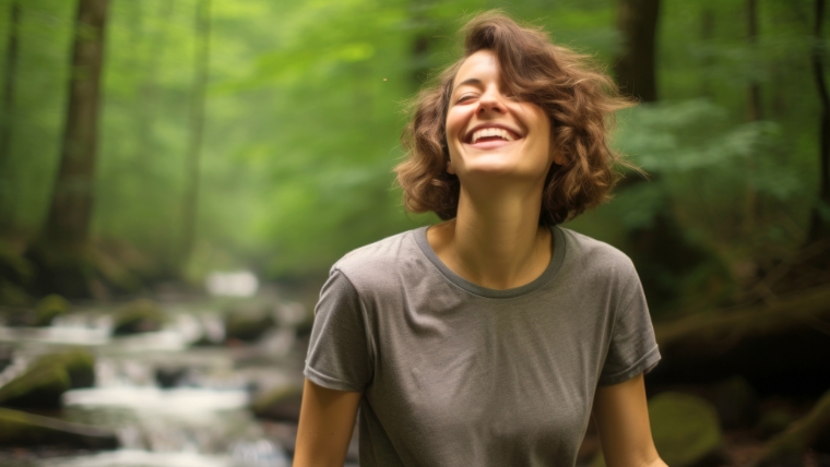 Boost Your Mental Health Treatment Success with Accelerated TMS Woman outside in nature looking happy | Boost Your Mental Health Treatment Success with Accelerated TMS | Mindful Health Solutions